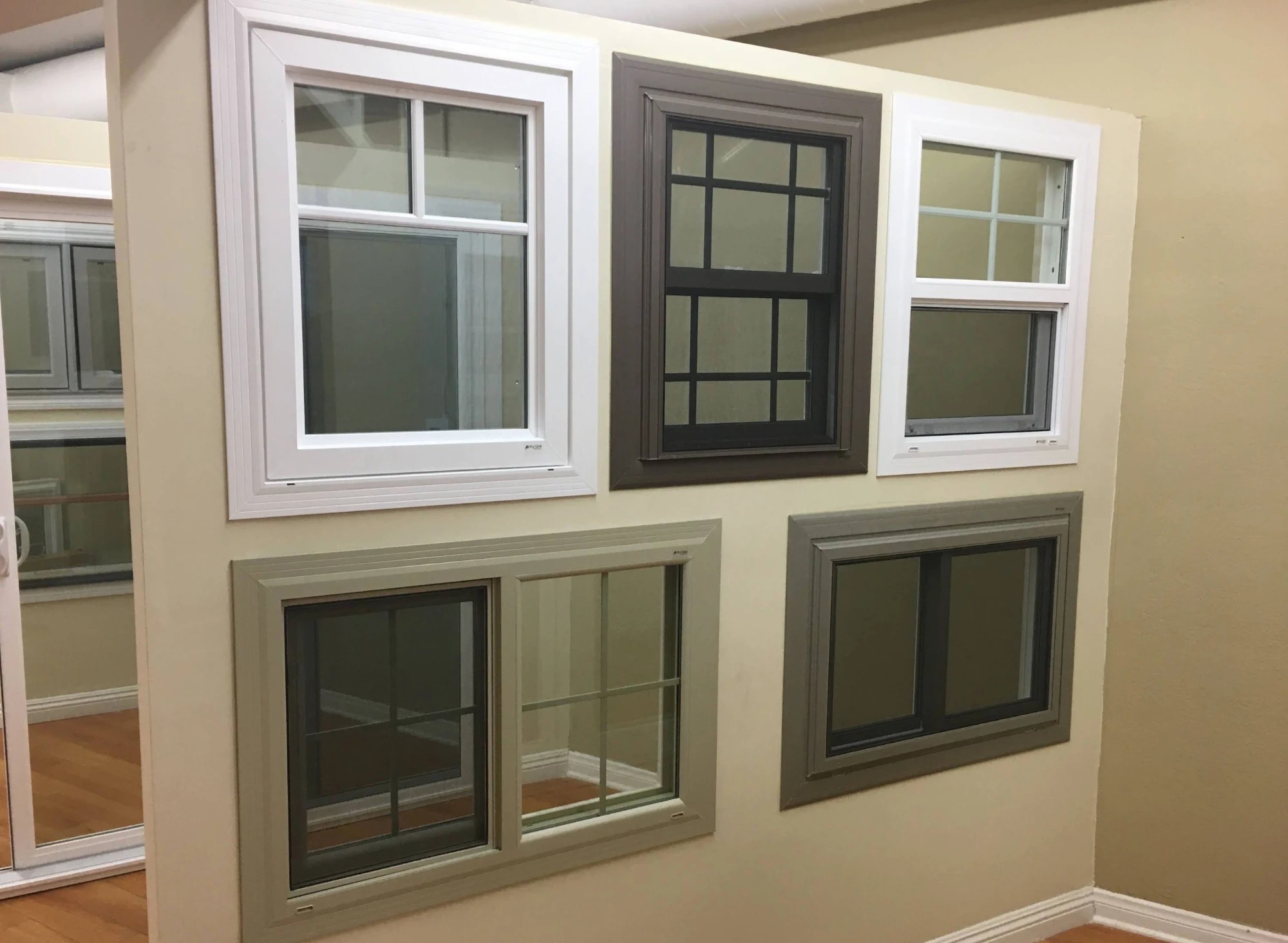 A wall of window units in the Canoga Park showroom, showing sliders, single-hung and picture styles side by side